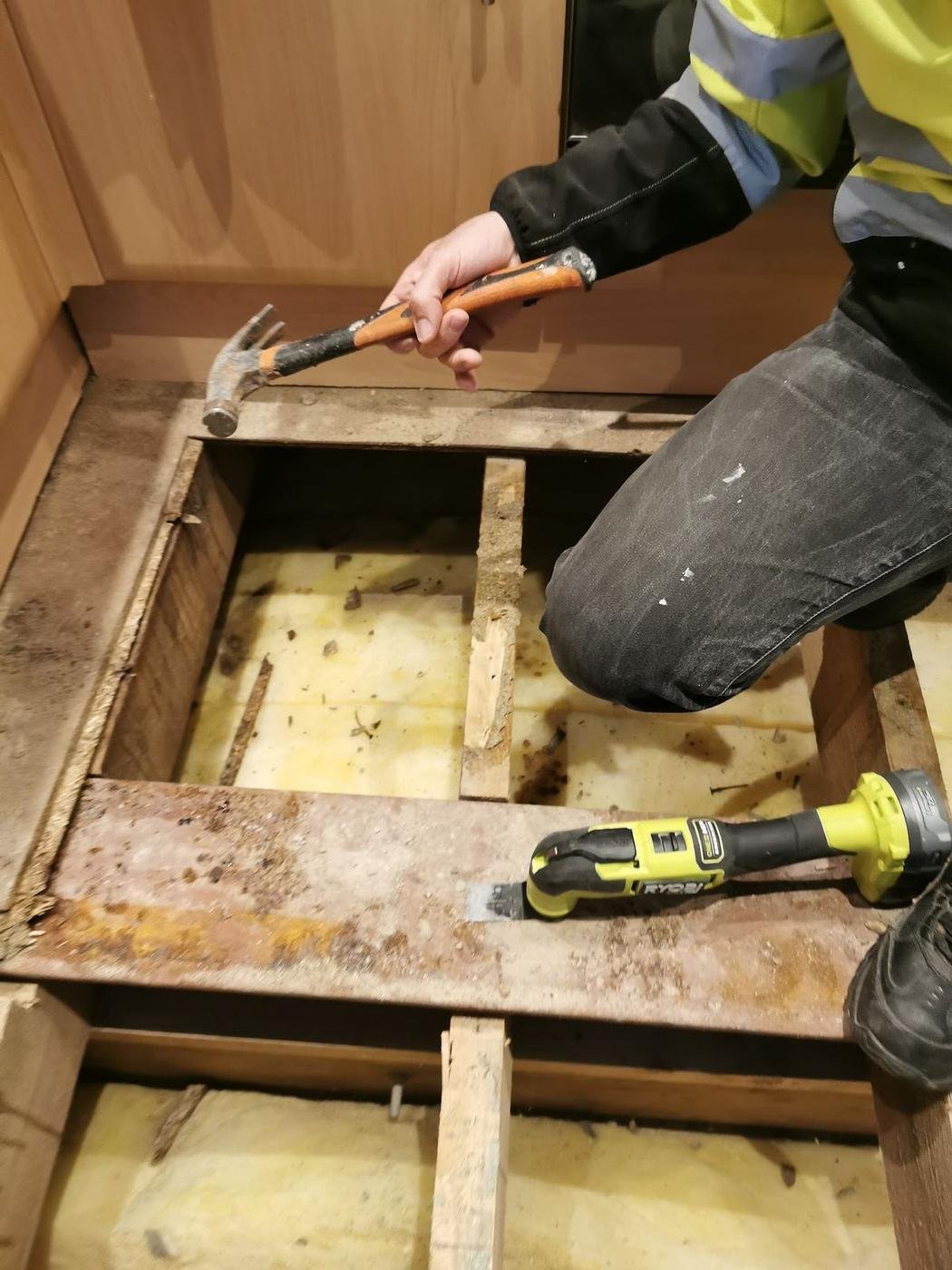 Floorboards lifted, with the joists and insulation showing